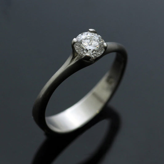 ROUND BRILLIANT CUT 0.5CT DIAMOND SET IN PLATINUM FLOWER ENGAGEMENT RING