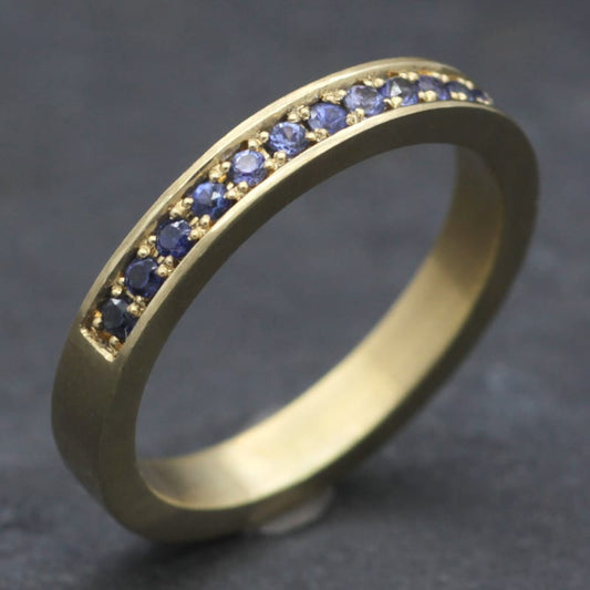 Eternity ring with blue sapphires made from recycled 18ct gold