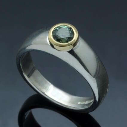 ROUND BRILLIANT CUT GREEN SAPPHIRE SET IN 18CT YELLOW GOLD & STERLING SILVER