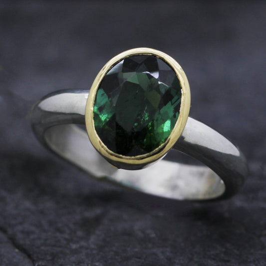 OVAL GREEN TOURMALINE SET IN 18CT YELLOW GOLD & STERLING SILVER